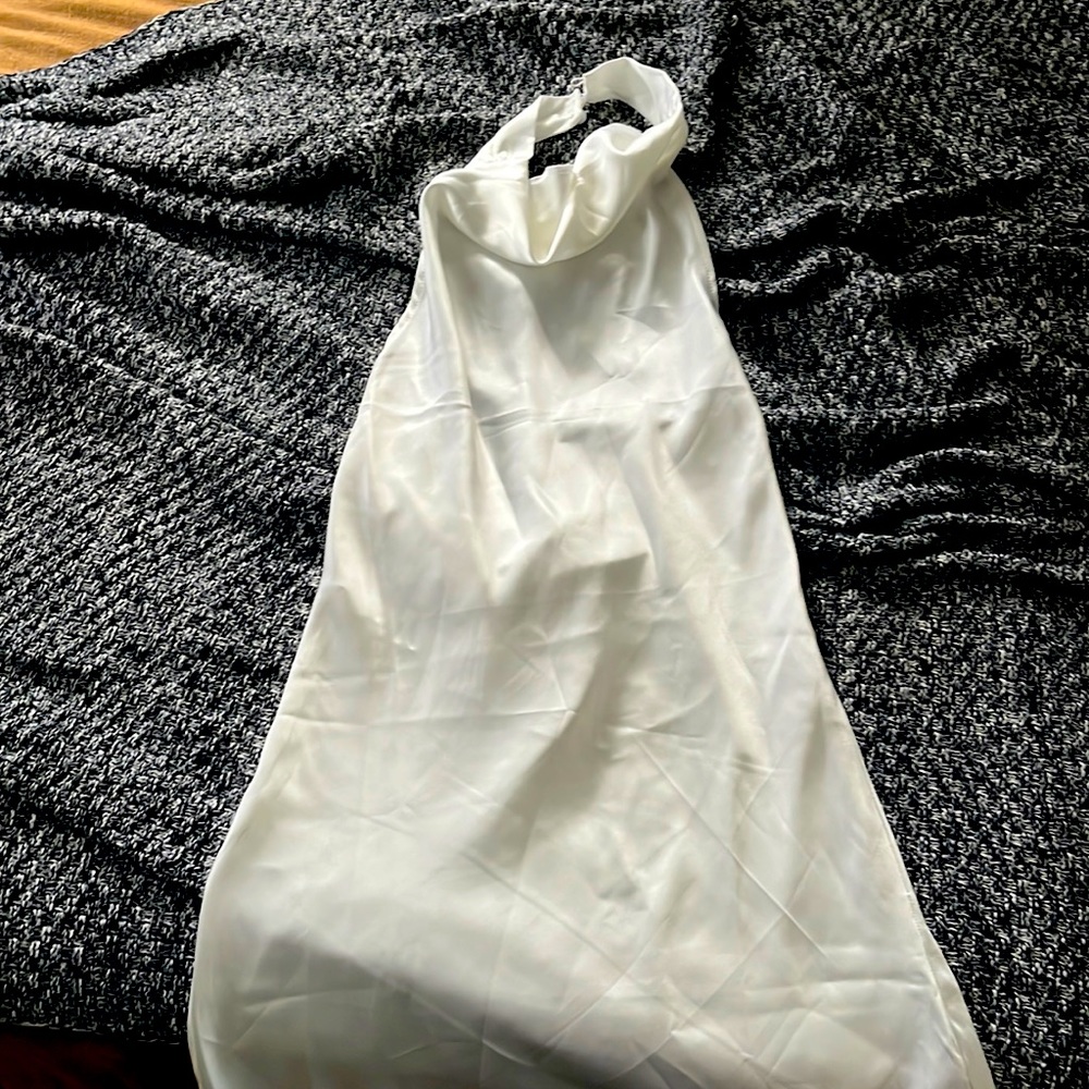 New mini white halter dress. Pearl like button details. Didn’t fit me.